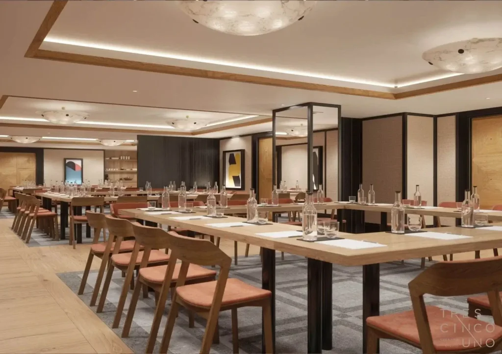 Modern conference room designed for meetings and events, featuring long tables in a U-shape, wooden chairs, bottled water, and notepads; abstract art decorates the walls.